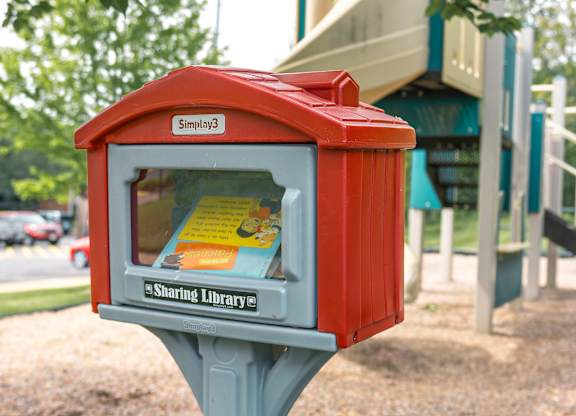 community library small red box with a glass window and a grey base.