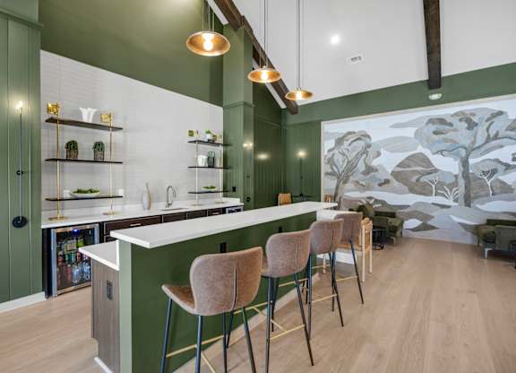 A kitchen with green walls and a white counter.