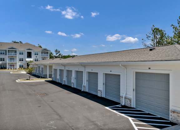 A row of garage doors in front of a building.