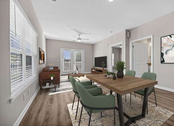 A dining room with a wooden table and green chairs.