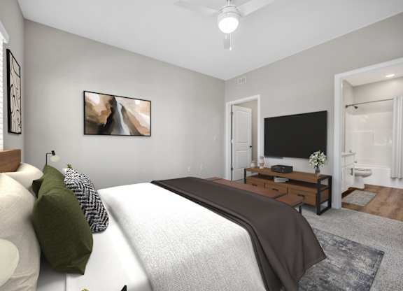 A bedroom with a large bed and a flat screen TV.