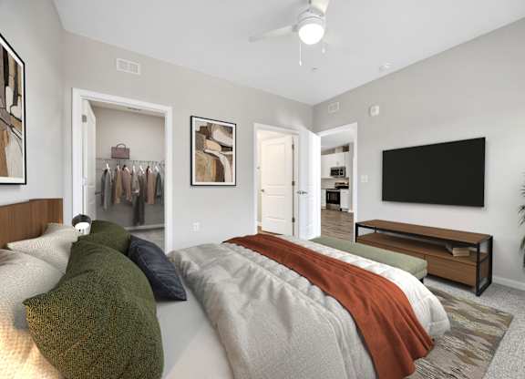 A bedroom with a bed, a wardrobe, a TV, and a plant.