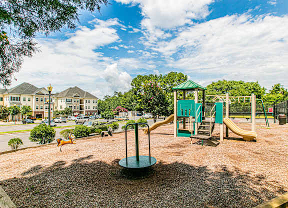 A playground with a green slide and a yellow slide. at Barrington Park Apartments, Manassas, VA, 20110