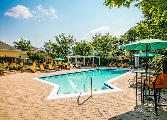 Pool surrounded by chairs at Broadlands Apartments, Ashburn, 20148