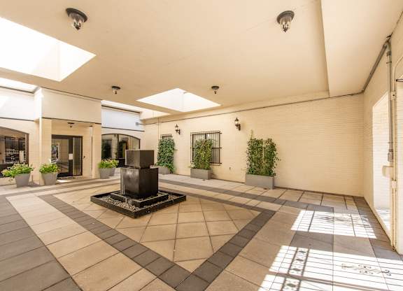 A courtyard with a fountain in the middle of it. at Columbia Uptown Apartments, Washington, DC, 20009