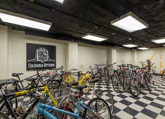 A bike parking area with a sign that says Columbia Uptown. at Columbia Uptown Apartments, Washington, 20009