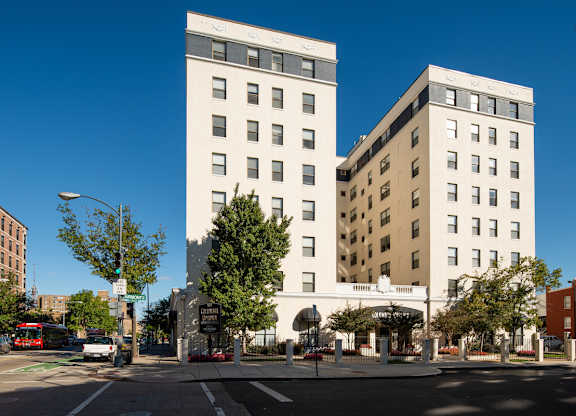 Two white buildings stand next to each other on a street corner. at Columbia Uptown Apartments, Washington, Washington DC