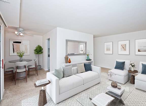 A living room with white furniture and a glass coffee table at Fairfax Square Apartments, Virginia, 22031