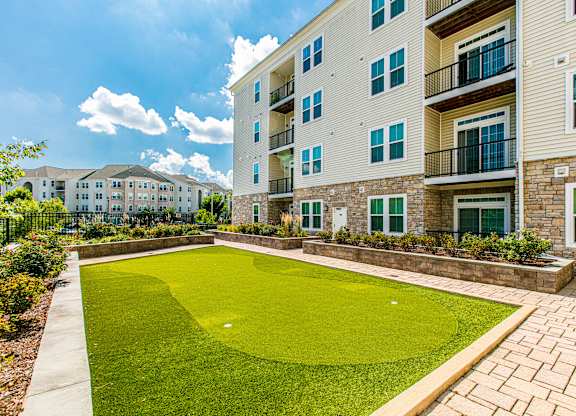 A large grassy area in front of a building. at Kensington Place Apartments, Woodbridge, Virginia