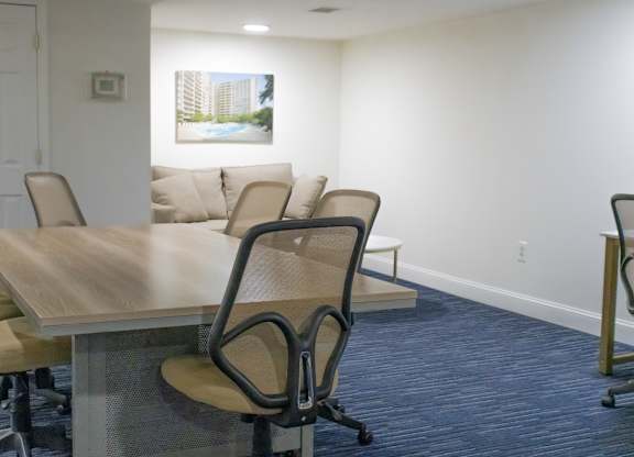 A conference room with a long table and chairs.