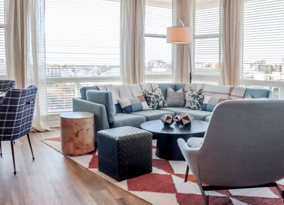 a living room with couches and chairs and a rug at Makers Rise, Herndon, VA 20171  