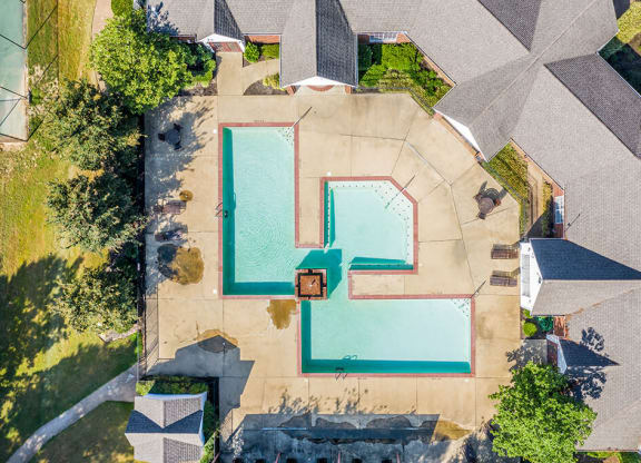 A swimming pool surrounded by a concrete patio and a grassy area at The Trails at Mt. Moriah, Memphis, 38115