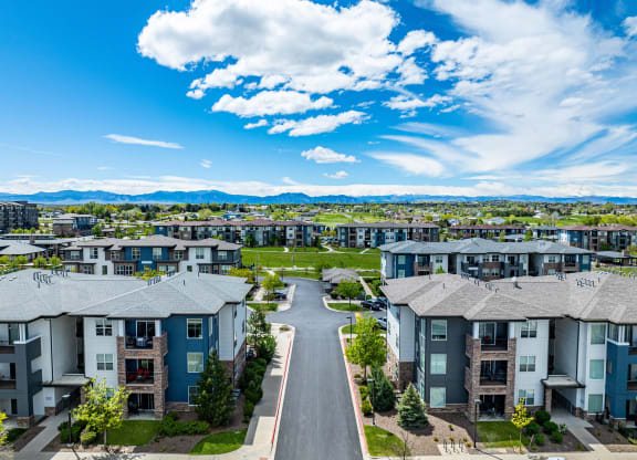 an aerial view of rows of apartment buildings with a road in the middle at Arbour Commons, Colorado, 80023