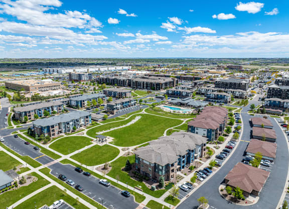 an aerial view of a city with buildings and a green park at Arbour Commons, Colorado, 80023