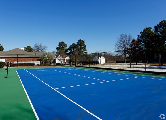 A tennis court with a green border and white lines at The Trails at Mt. Moriah, Memphis, TN 38115