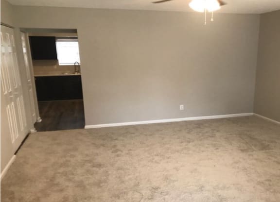 A room with a ceiling fan and carpeted floor at Diamond Townhomes, South Carolina