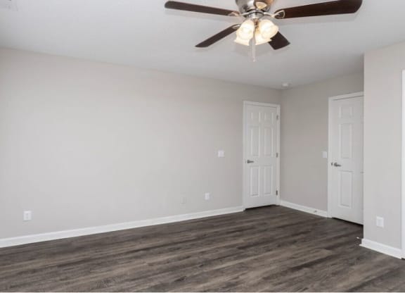 A room with a ceiling fan and wooden flooring at Diamond Townhomes, Beaufort