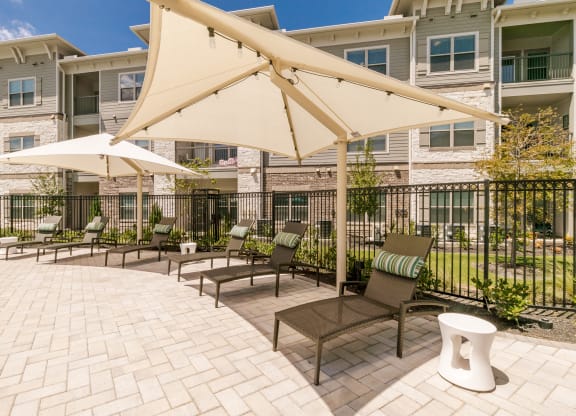 Poolside Relaxing Chairs at Cue Luxury Apartments, Texas