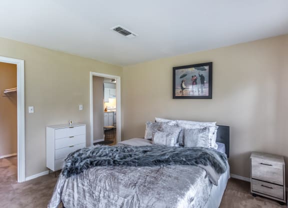 a bedroom with a bed and a dresser and a bathroom at The Trails at Mt. Moriah, Memphis, Tennessee