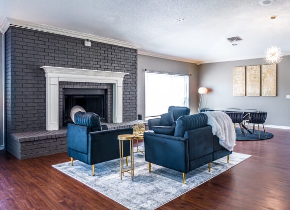 a living room with blue furniture and a brick fireplace at The Trails at Mt. Moriah, Tennessee