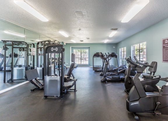 a gym with cardio machines and other exercise equipment at The Trails at Mt. Moriah, Tennessee 38115