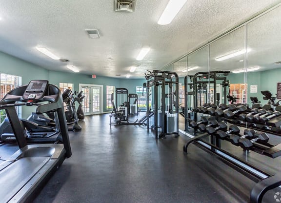 A gym with treadmills, weights, and exercise machines at The Trails at Mt. Moriah, Memphis, 38115