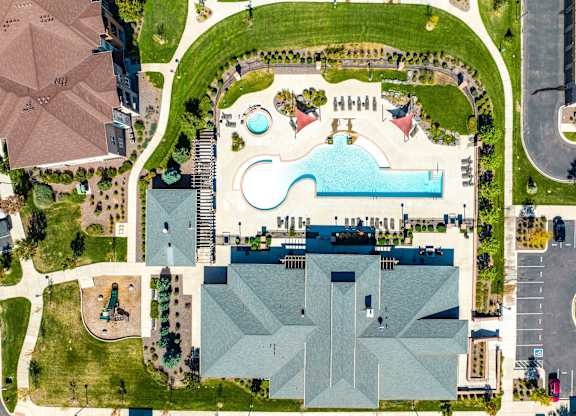 A large building with a pool in front of it.