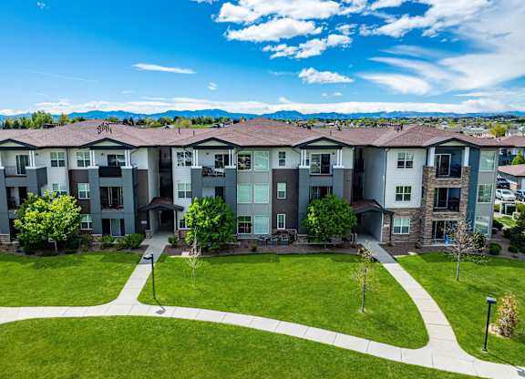 Apartment complex with a green lawn in front.