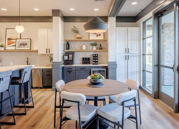A modern kitchen with a dining table set for four.