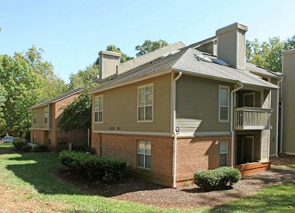 A two story house with a balcony on the second floor.