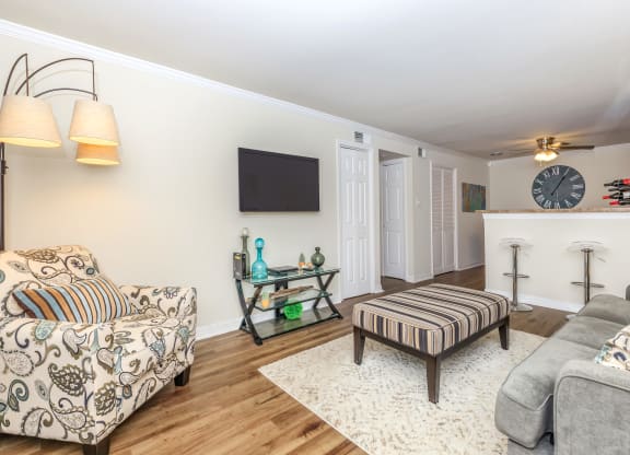a living room with two couches a coffee table and a tv on the wall