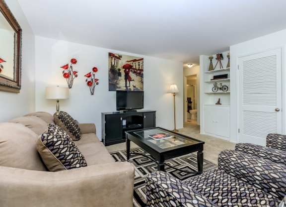a living room filled with furniture and a flat screen tv