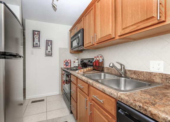 the kitchen has granite countertops and stainless steel appliances