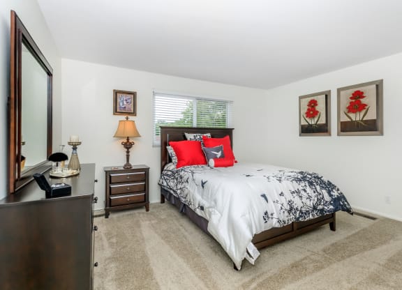 a bedroom with a bed and a dresser