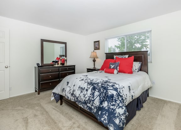 a bedroom with a bed and a dresser