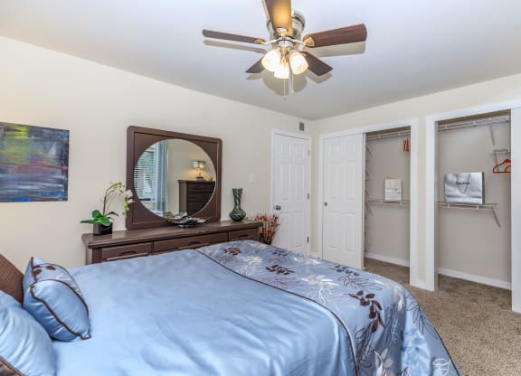 a bedroom with a large bed and a ceiling fan