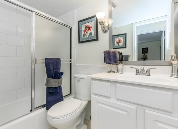 a bathroom with a toilet sink and shower