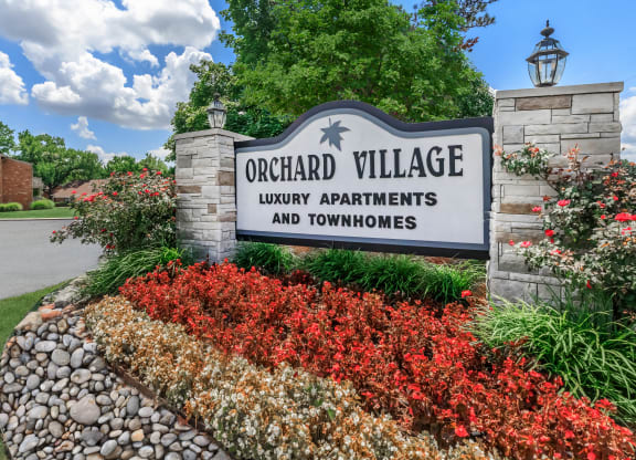 a sign that reads orchard village luxury apartments and townhomes
