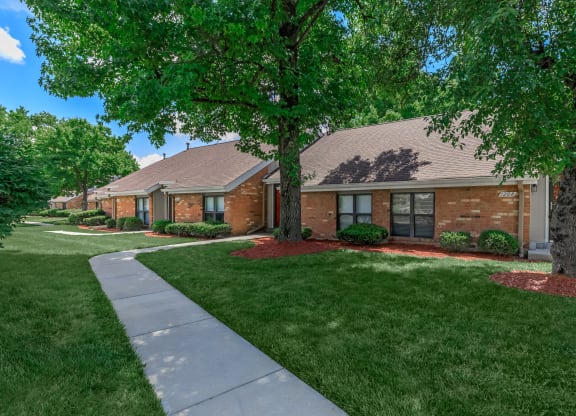 a row of houses with trees in front of them