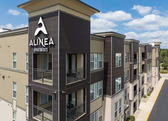 A view of Alinea Apartments with a clear blue sky in the background. at Alinea Town and Country Luxury Apartments in Des Peres MO 63131.