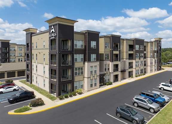 A parking lot in front of apartment buildings.