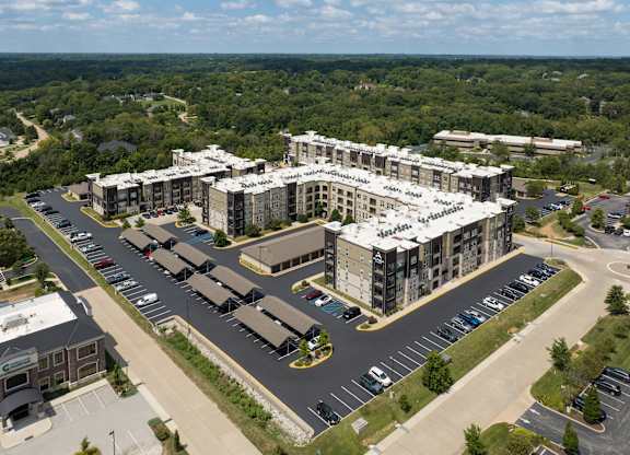A large building with a parking lot in front of it at Alinea Town and Country Luxury Apartments in Des Peres MO 63131..