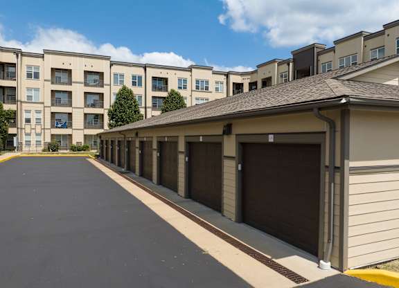 A long row of garage doors in front of apartment buildings at Alinea Town and Country Luxury Apartments in Des Peres MO 63131..