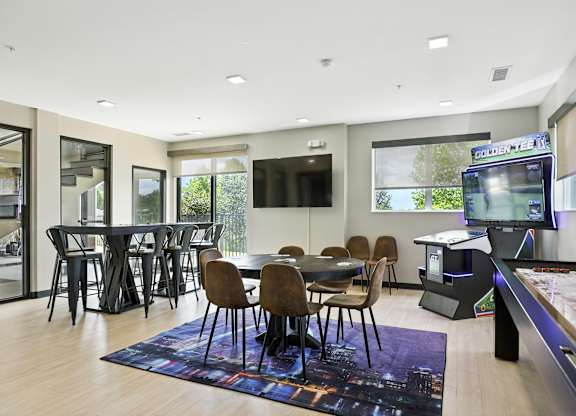 A modern room with shuffleboard, poker, golden tee, and workspace  at Alinea Town and Country Luxury Apartments in Des Peres MO 63131.