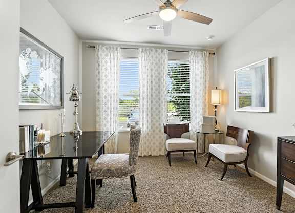 A well-lit dining room with a table set for four at Alinea Town and Country Luxury Apartments in Des Peres MO 63131..