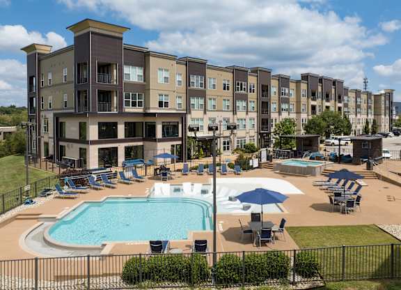 A large apartment complex with a pool and a hot tub at Alinea Town and Country Luxury Apartments in Des Peres MO 63131..