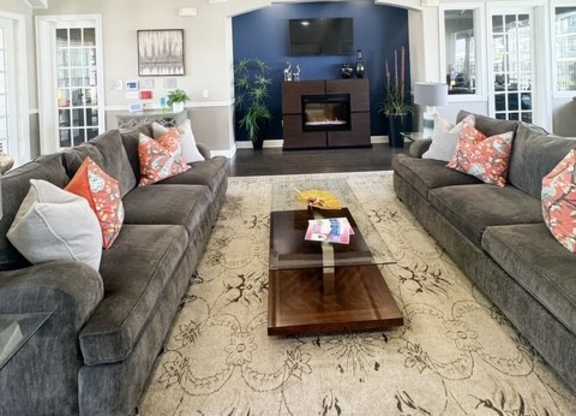 A living room with a grey couch and a coffee table.