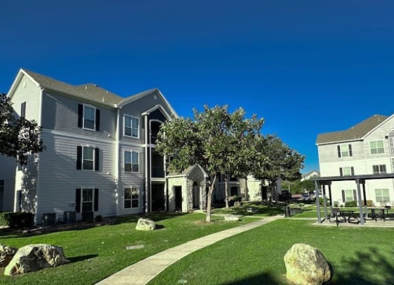 a group of houses with a yard and grass