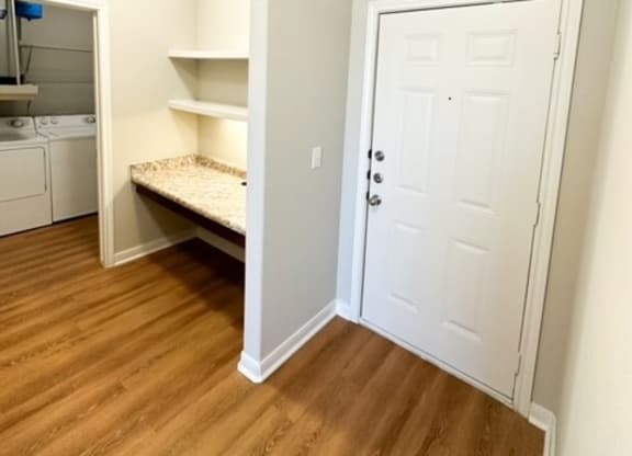 a room with a closet and a white door