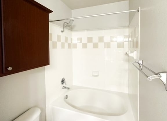 a white bathroom with a toilet and a sink